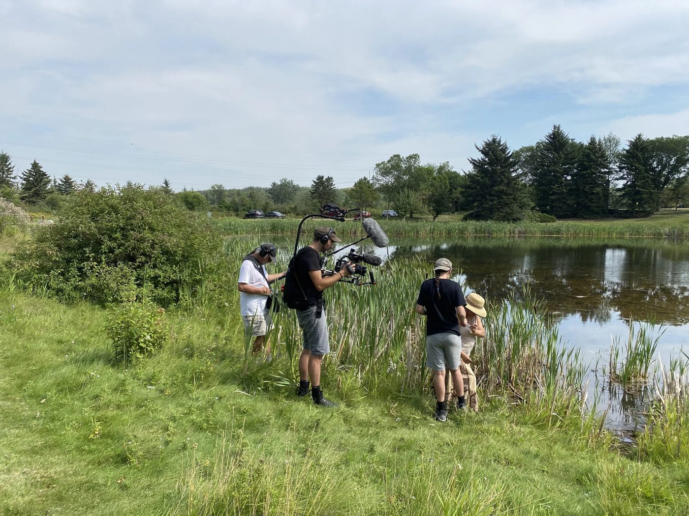 A film crew from Fuse recording by a prairie wetland